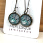 Long green glass dome fantail (Piwakawaka) earrings