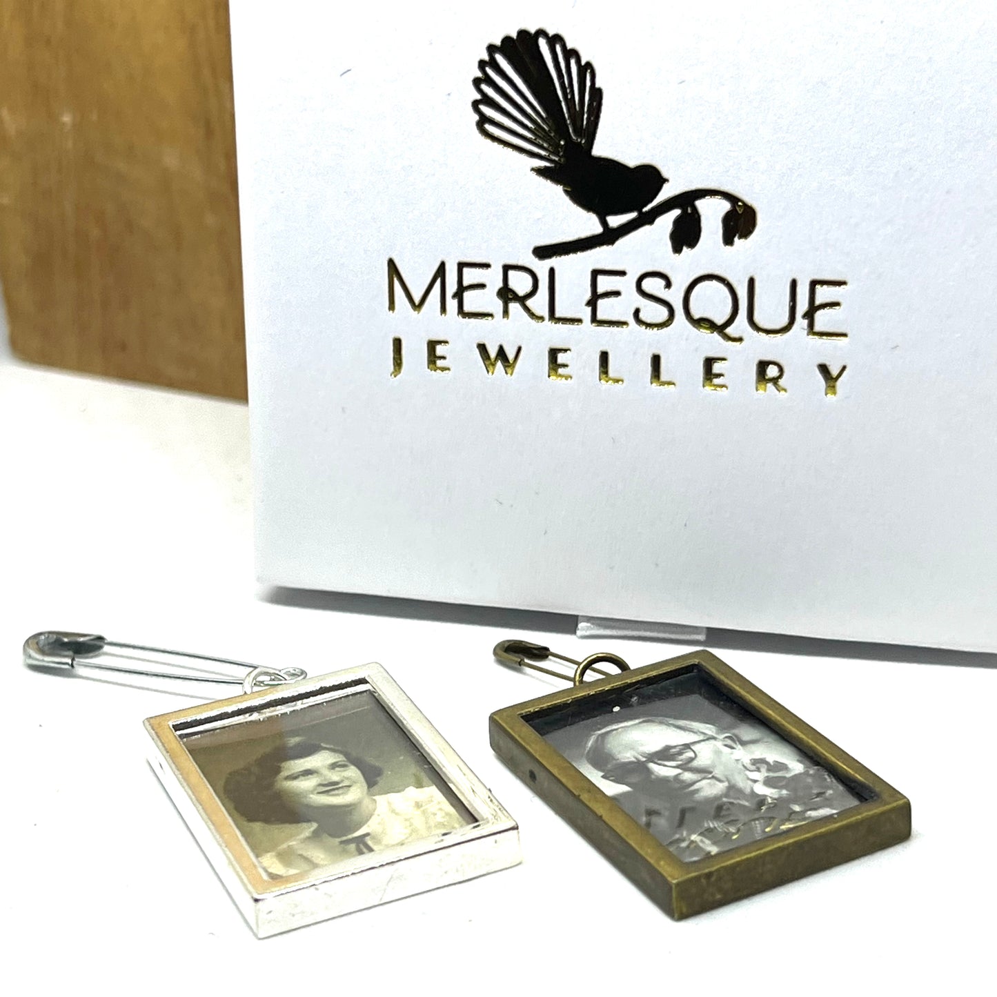 Silver and bronze DIY photo charms with safety pins.