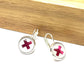 Hot pink kiss glass dome earrings on a dove grey background